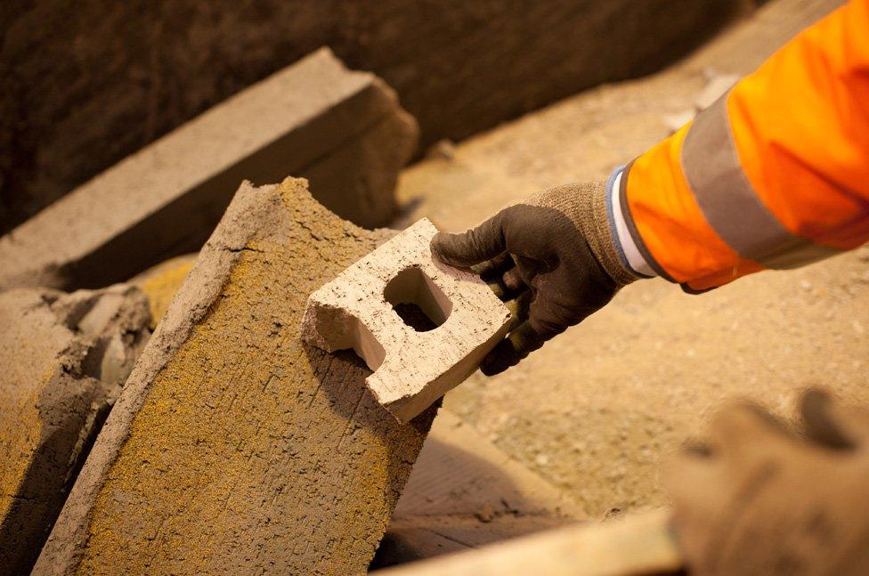 Worker holds brick