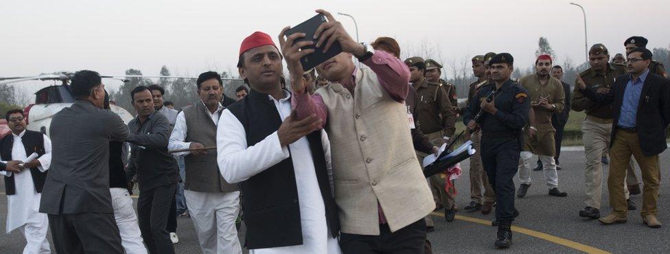 A supporter takes a selfie with Akhilesh Yadav