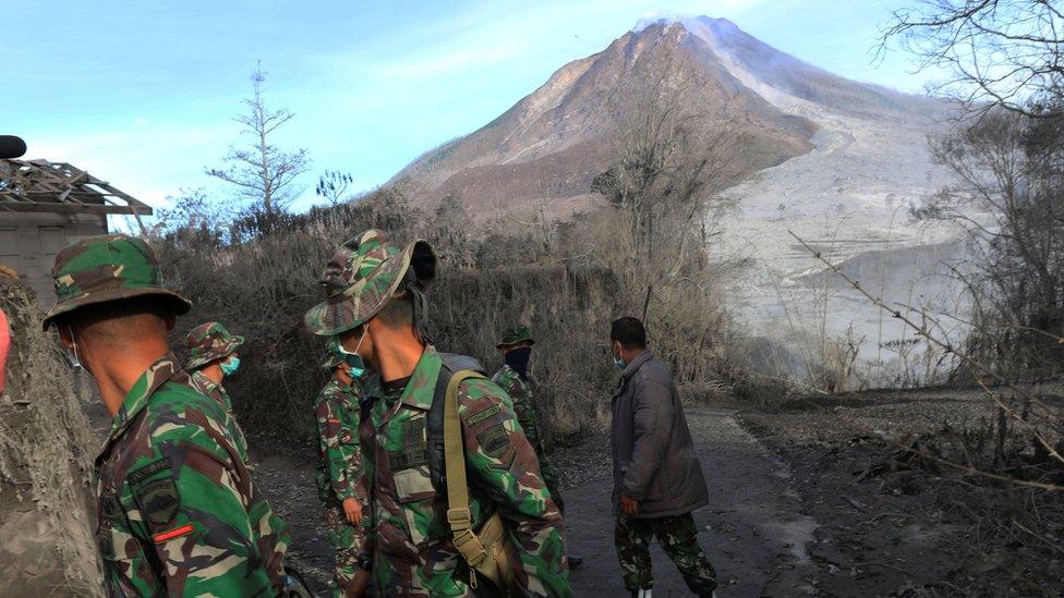 Indonesian soldiers search an area following a deadly eruption of Mount Sinabung volcano in Gamber Village, North Sumatra, Indonesia 22 May 2016