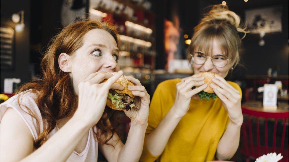 Friends eating burgers