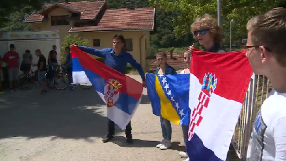 Students holding the Serbian, Bosnian and Croatian national flags during a protest in July