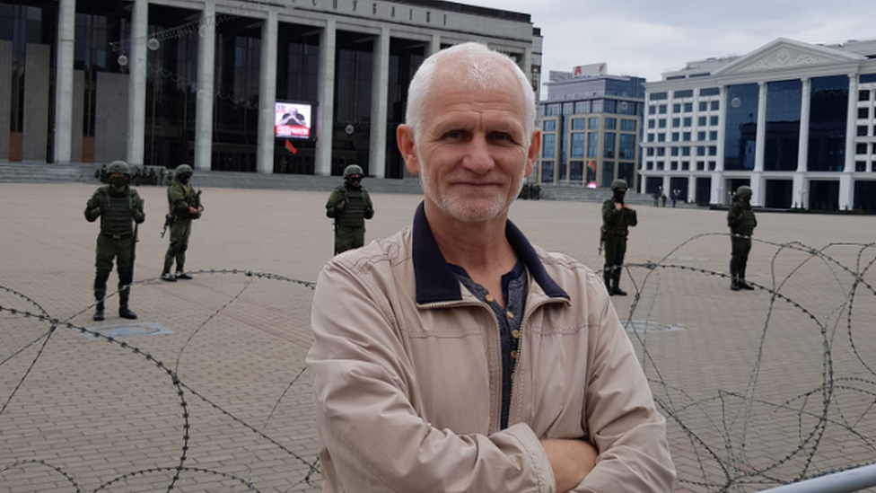 A Facebook picture of Ales Bialiatski standing in front barbed wire and armed Belarusian soldiers. Photo: September 2020