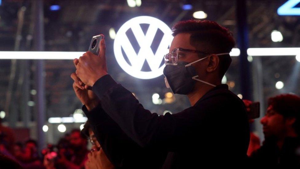 A visitor wears a mask as a precautionary measure against Corona virus at the Volkswagen showcasing hall during the India Auto Expo 2020 in Greater Noida, India, 05 February 2020.