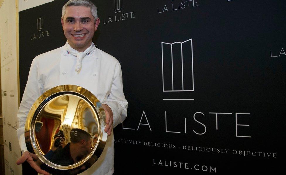 French Swiss Chef Benoit Violier of the restaurant Hotel de Ville in Crissier, Switzerland, poses with his trophy for the best restaurant of the World during the award ceremony of "La Liste" (The List) at the French Foreign Ministry in Paris, Thursday, Dec. 17, 2015.