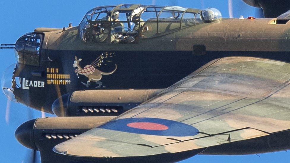 Close-up of the cockpit and left wing as Flt Lt Seb Davey pilots the Lancaster Bomber during coronation rehearsals