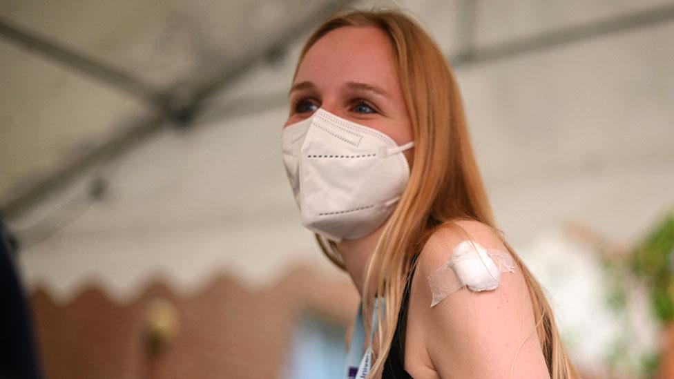 A student waits before leaving after receiving a dose of the Pfizer/BioNTech Covid-19 vaccine at a vaccination centre at the Hunter Street Health Centre in London on June 5, 2021.