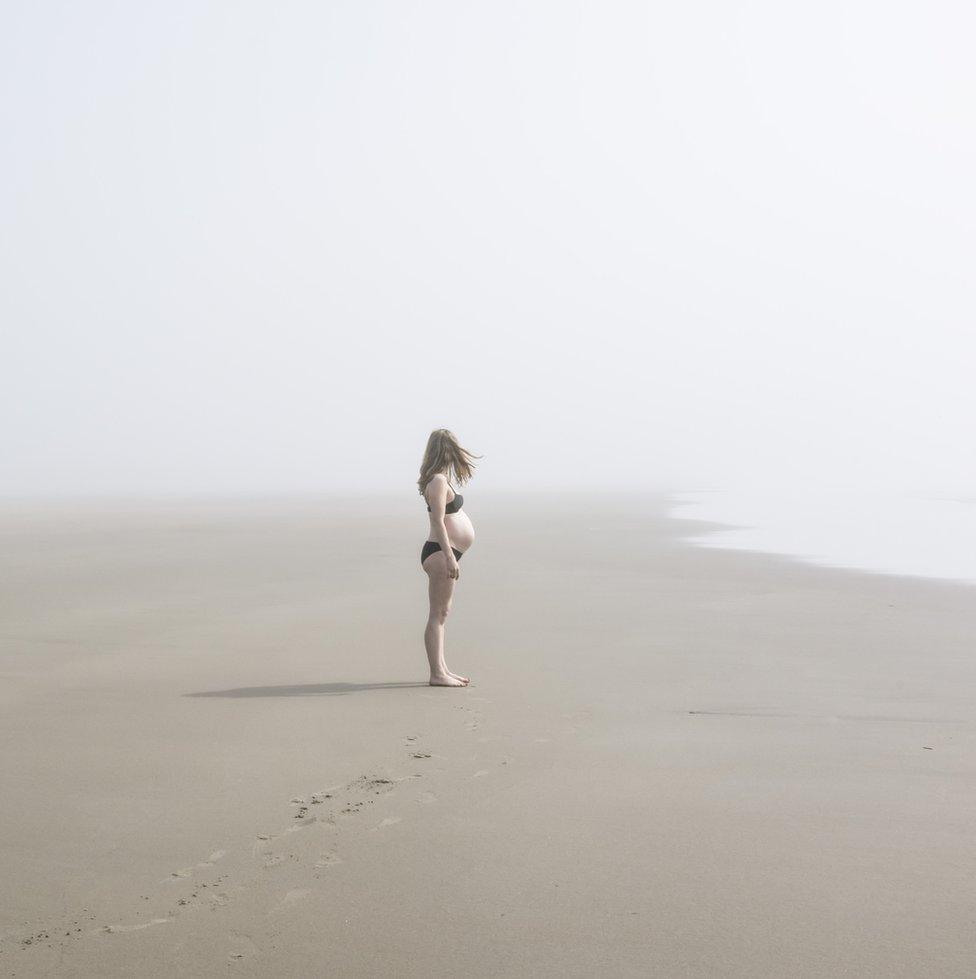 A pregnant woman on a beach