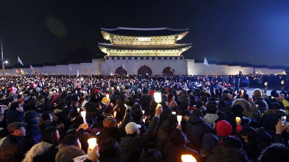 South Koreans attend a candlelight protest during a rally against president Park Geun-hye