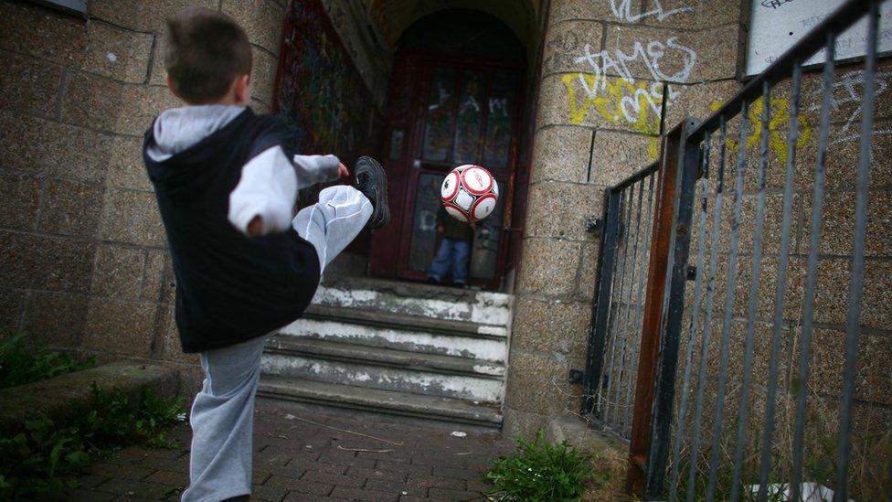 A boy kicking a football