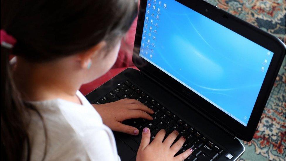 A child using a laptop computer