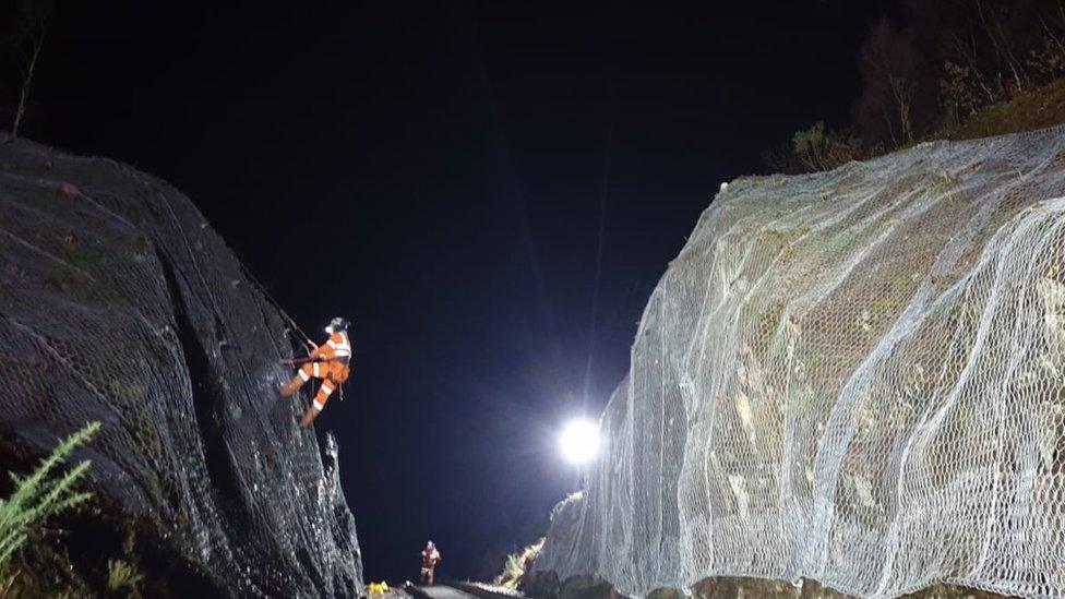 Installing protective netting at a rock cutting