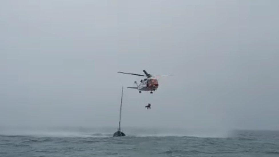 the helicopter rescues the unwell crew member