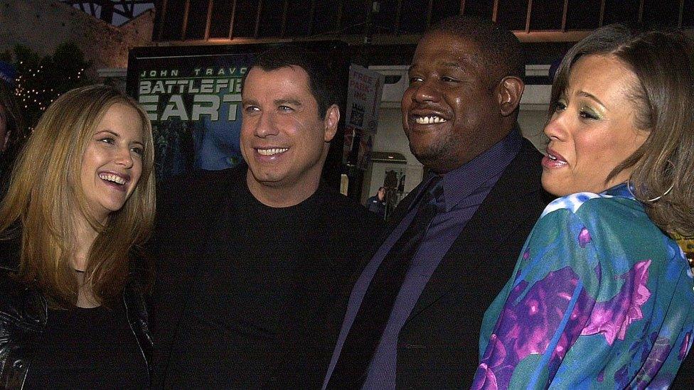 (From L-R:) Kelly Preston, her husband John Travolta, Forest Whitaker and his wife Keisha at the premiere of Battlefield Earth, 10 May 2000