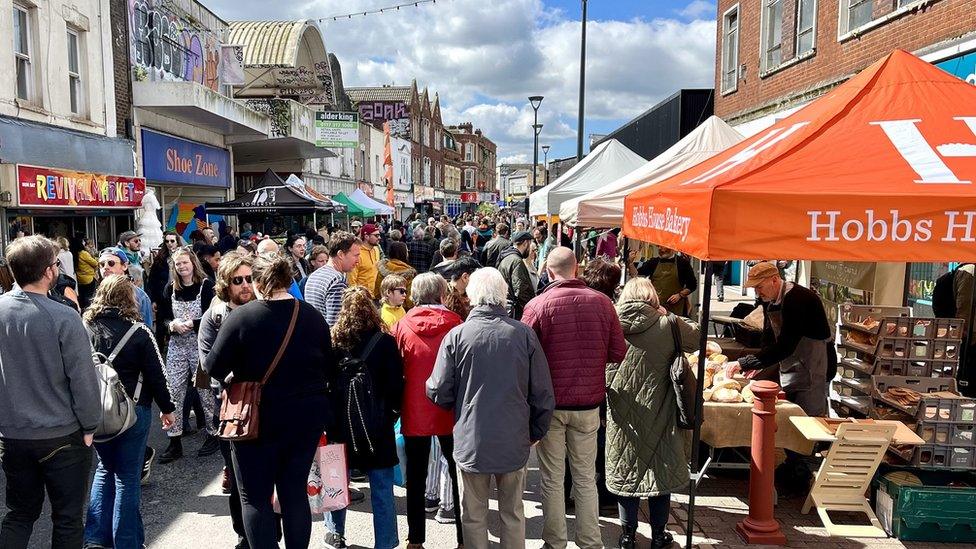 Crowds at a food festival on East Street, with the entrance to St Catherine's Place visible on the left