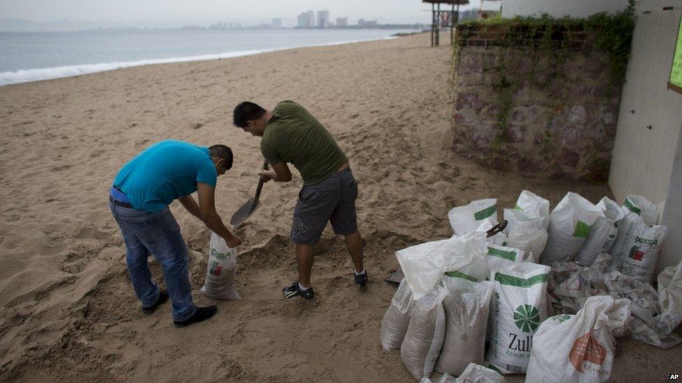 Men fill sandbags in Mexico