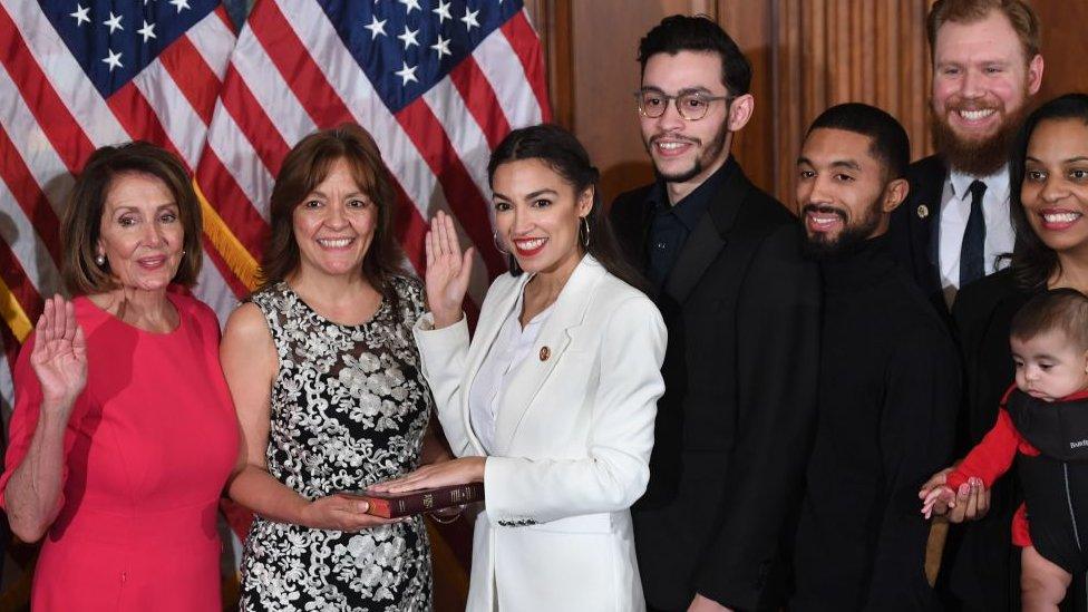 Ms Ocasio-Cortez (in white) was sworn in on Thursday as the youngest ever US congresswoman