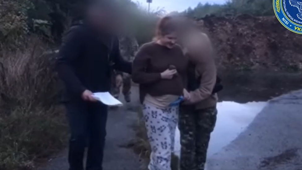 She can be seen, looking heavily pregnant, in a video of the exchange released by Ukrainian authorities.