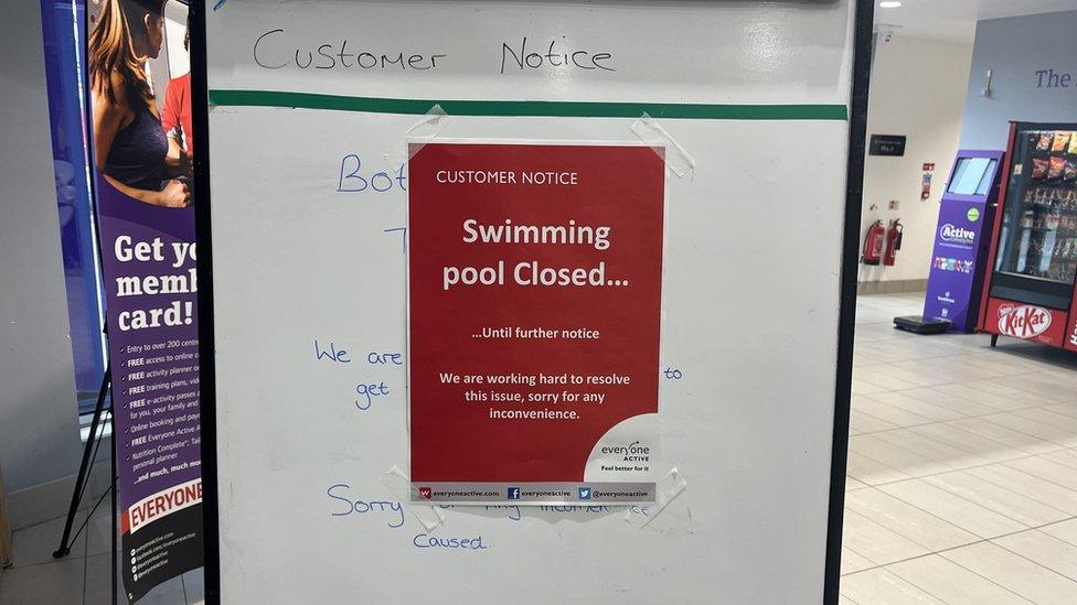 A sign explaining the pool is remaining closed until further notice