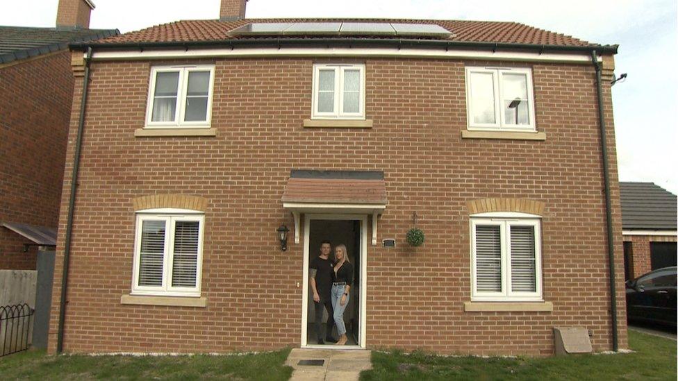 Natasha Roughton and partner Neil outside their home