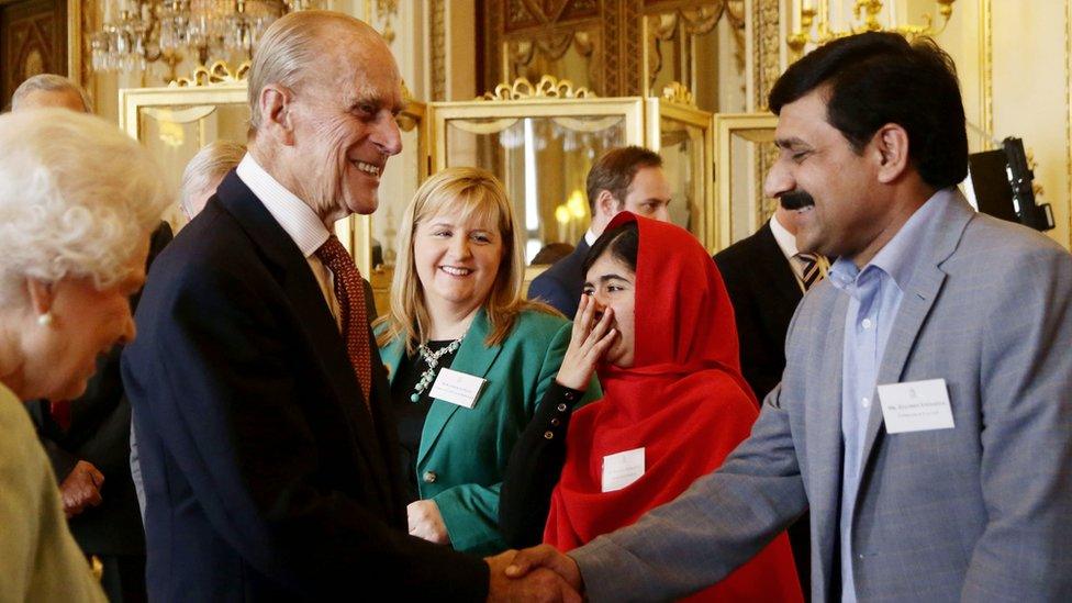 Malala Yousafzai and other guests meeting the Queen and Duke of Edinburgh