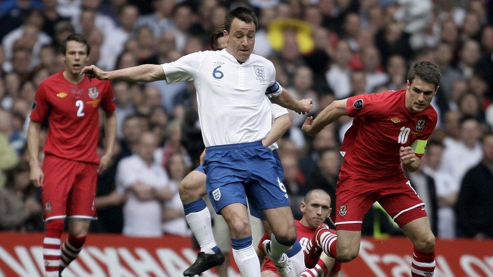 Ramsey became the youngest ever player to captain Wales. Here he is (right) battling with England's John Terry (centre) in 2012.