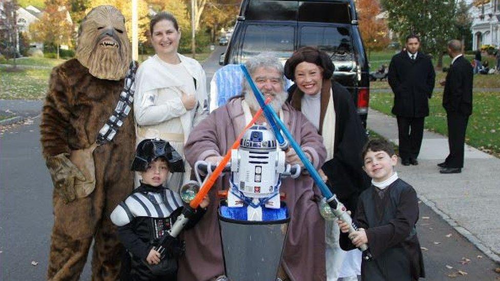 Chuck Blazer on scooter in Star Wars costume, surrounding by fellow Star Wars characters