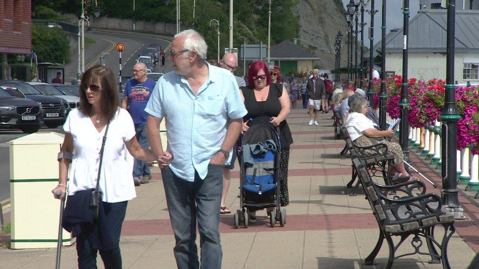 People walking along Penarth seafront