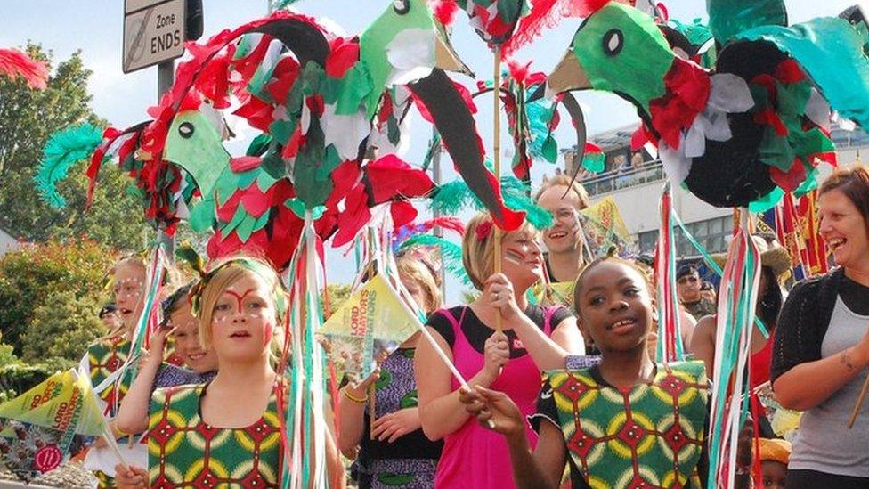 Children and adults in colourful costume walking down St Stephens Street in Norwich during Lord Mayor's Procession in 2011