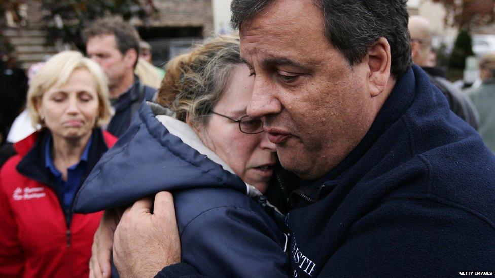 New Jersey Gov. Chris Christie (R) tries to comfort Alice Cimillo whose home was damaged by Superstorm Sandy November 1, 2012 in Moonachie, New Jersey