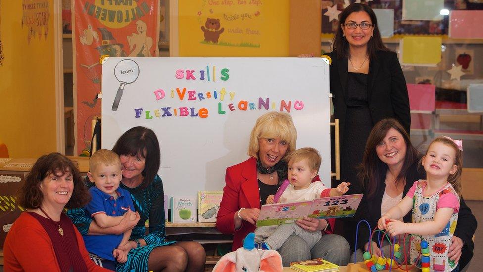 Older staff with children in a nursery