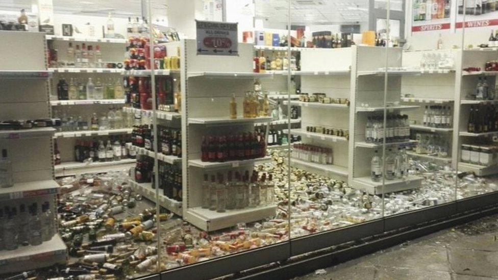 Fallen bottles are seen in a liquor store following an earthquake on the island of Kos,