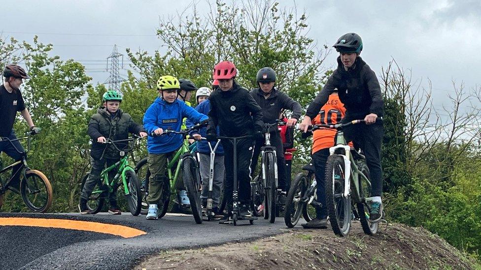 Youngsters on bikes ride on the track