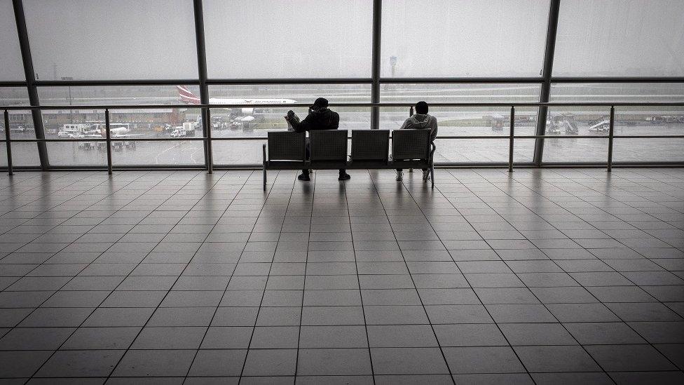 Travellers at a near empty airport