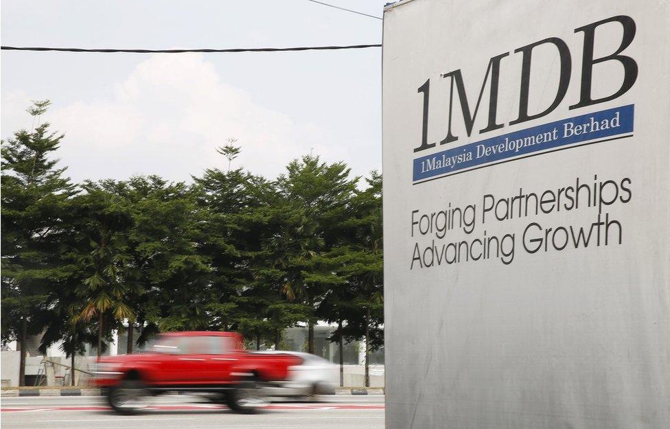 Traffic passes a 1Malaysia Development Berhad (1MDB) billboard in Kuala Lumpur