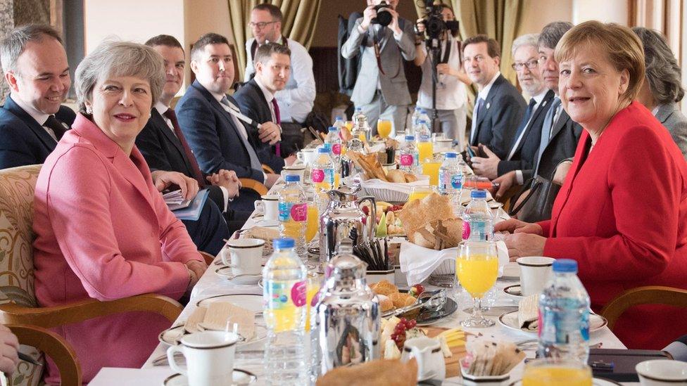 Theresa May at a breakfast meeting with Angela Merkel at the EU-League of Arab States Summit in Sharm El-Sheikh