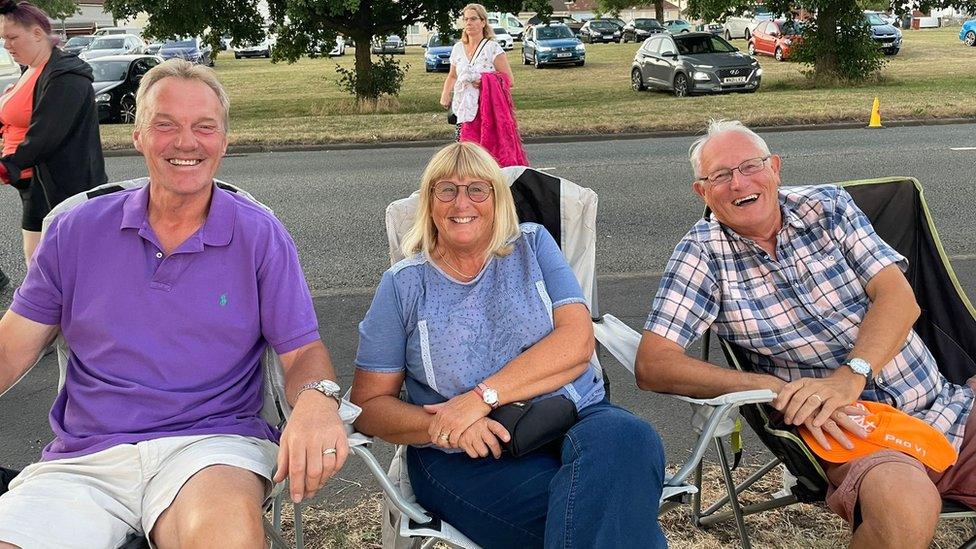 People at Bedminster Down watch the hot air balloons