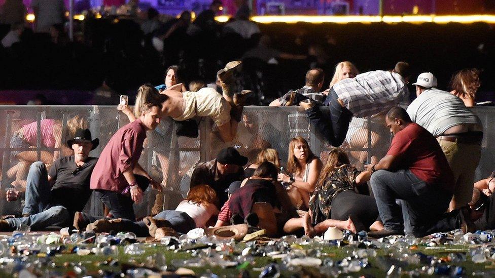 People at concert duck behind barrier and take cover