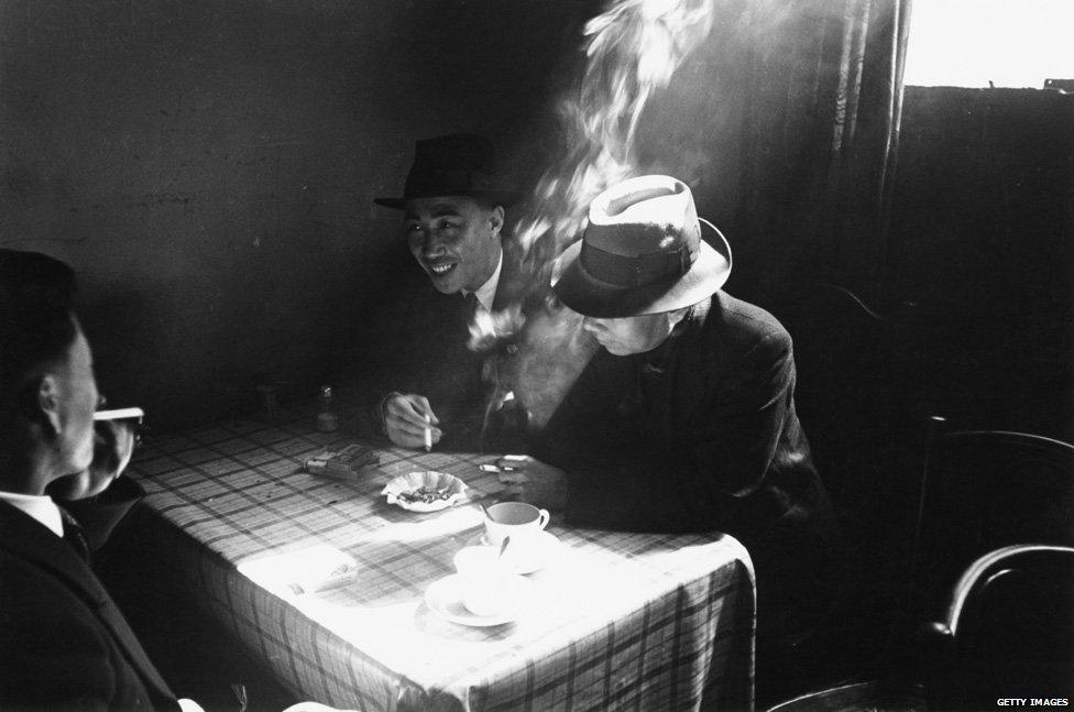 Chinese seamen chatting and smoking at a Chinese hostel in Liverpool, May 1942