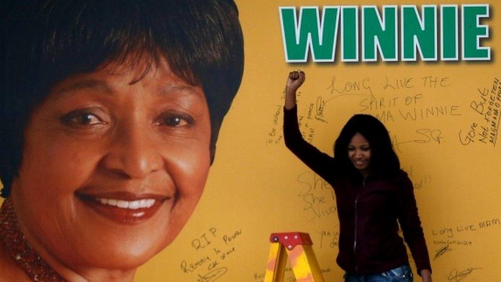 A women gestures after writing on a tribute wall with the portrait of the late Winnie Mandela, after its unveiling outside Luthuli house, the ANC headquarters in Johannesburg, South Africa April 9, 2018.