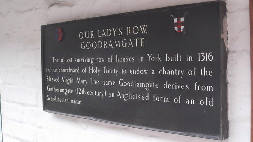 Image of a sign on Goodramgate about the history of the building