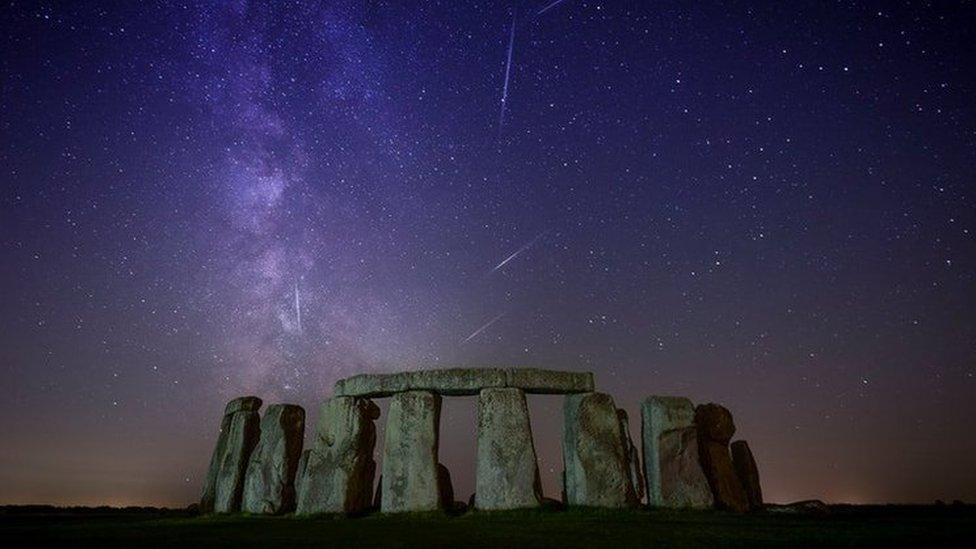 Stonehenge under a purple night sky