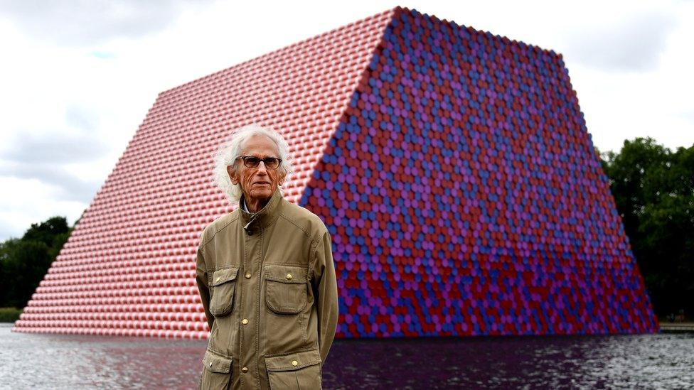 Bulgarian artist Christo stands in front of his artwork Mastaba, built on the Serpentine lake in London, 18 June 2018