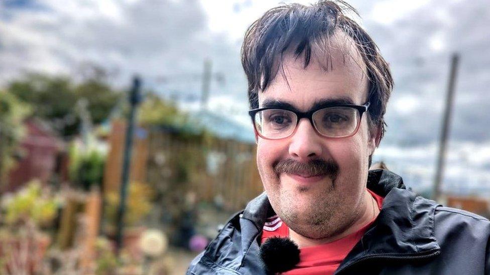 William Hendren wearing glasses and a moustache looking towards the camera.