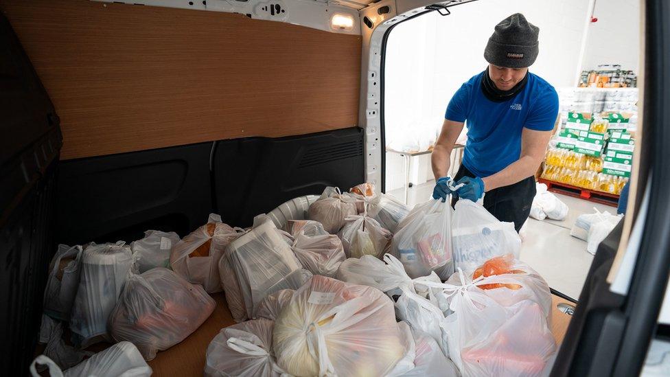 Volunteers help load a delivery van in Enfield