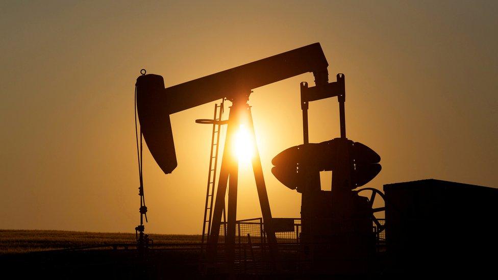 An oil pump jack pumps oil in a field near Calgary, Alberta