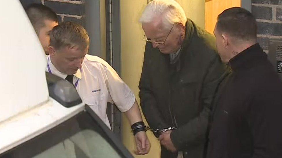 Gordon Anglesea being led away in handcuffs