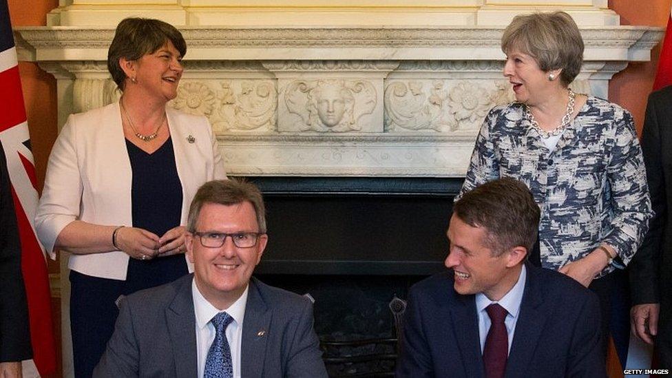 Theresa May and Arlene Foster witness the signing of the Conservative-DUP pact