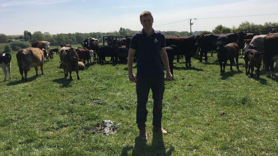 Richard on Lower Drayton Farm in a field of cows