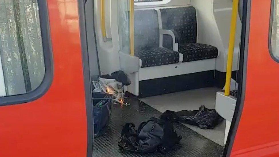 Pictures show a white bucket on fire inside a supermarket bag, with wires trailing on to the carriage floor