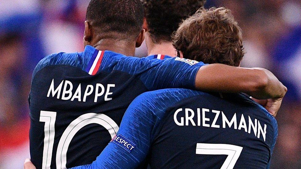 Mbappe and Griezmann hugging one another